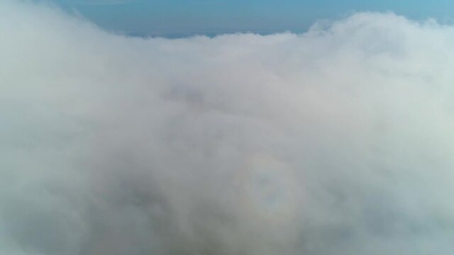 Flight over the fog, high above the mountains of the Ukrainian Carpathians. Polonina Borzhava. Mount Gemba.