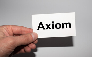 Message on the card AXIOM, in hands of businessman.