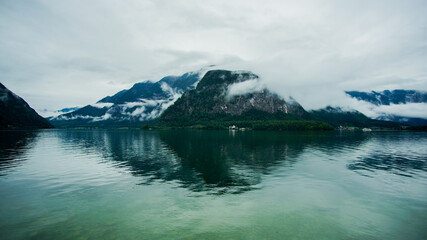 Mirror reflection of foggy mountain on Lake Hallstatt