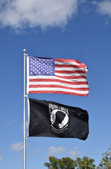 american flag and POW MIA flag in the wind