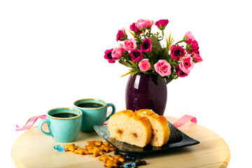 Sweet homemade cakes with apples and coffee in the morning. Two slices of sponge Apple pie, cups of espresso and star shaped crackers on a blue plate, dessert close up. Side view with copy space.