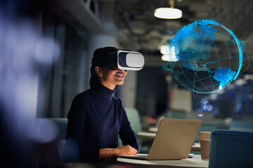 Businesswoman with virtual reality glasses looking at virtual globe