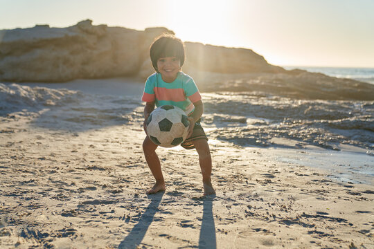 Portrait Cute Boy Playing With Soccer Ball On Sunny Beach