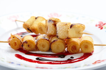 fried sweet rolls with berry sauce