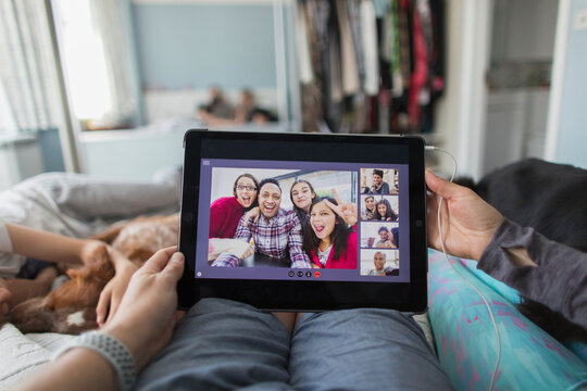 POV Woman With Digital Tablet Video Chatting With Friends On Bed