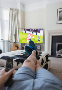 POV Man Watching Soccer Match On TV In Living Room