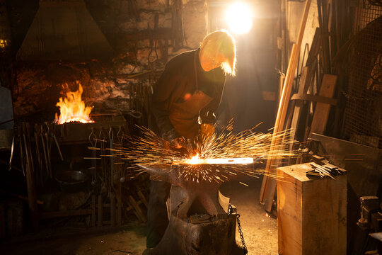 Female blacksmith working in workshop