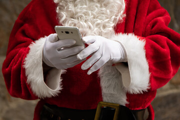 closeup of santa claus hands with mobile phone