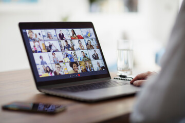 Colleagues video conferencing on laptop screen