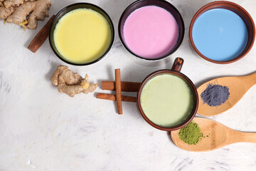 Assortment of colorful Japanese tea latte, golden turmeric, matcha, blue, pink moon milk. Anti-inflammatory, immunity-boosting, alternative medicine, selective focus