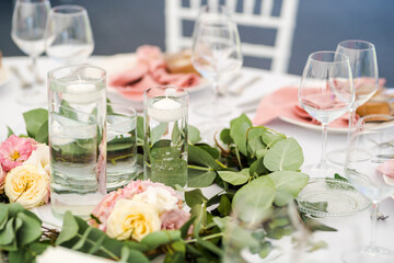 Luxury wedding table decoration in pink and white. Special event table set up. Fresh flower decoration.