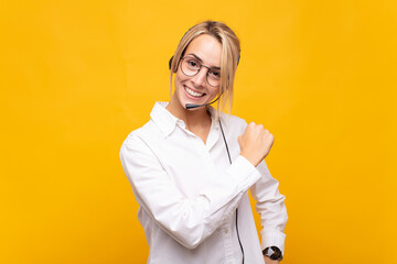 young woman telemarketer feeling happy, positive and successful, motivated when facing a challenge...