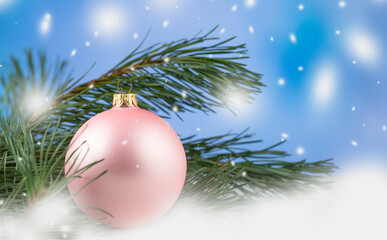 Fototapeta na wymiar Christmas. New Year's and Christmas. Christmas card background. Pink ball and branches of a Christmas tree. Snow. copyspace