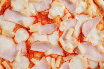 Hawaii pizza topping with pineapple and ham close-up. Cooking concept in the style of Italian cuisine.
