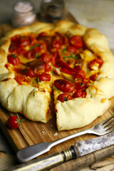 Selective focus. Macro. Delicious homemade galette with cherry tomatoes and cheese.