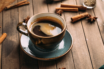Aromatic black coffee on dark wooden background