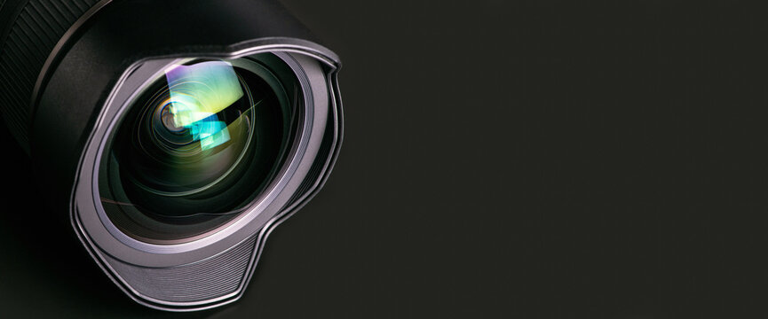 Camera lens on a black background. Wide-angle close-up lens. Macro. Banner.