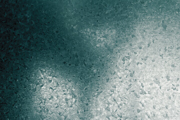 Degraded shadow on a metal plate with strange geometric drawings painted on its surface. Abstract dark background with bright texture bumps and spots.