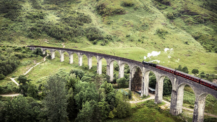 Aerial photo of famous steam train on glenfinnan viaduct