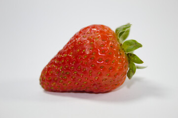 Strawberry with green leaves and white background
