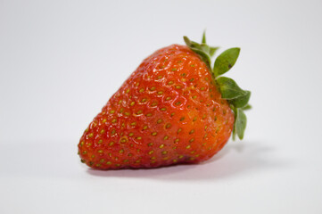 Strawberry with green leaves and white background