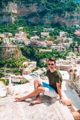 Fototapeta na wymiar Summer holiday in Italy. Young man in Positano village on the background, Amalfi Coast, Italy