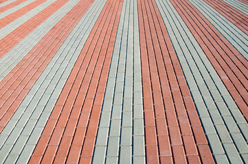 The paving slabs are white and red. Tile texture