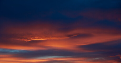 Naklejka na ściany i meble Clouds during sunset, orange