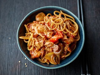 fried noodles and vegetables with hot chicken sauce