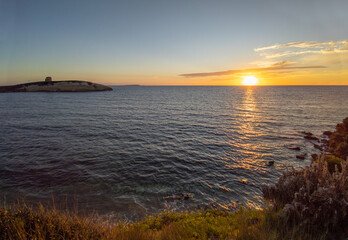 Obraz premium S'Archittu (Italy) - The little arch, in the Sardinian language, is a small coastal touristic town in province of Oristano, Sardinia region and island. Here a view at sunset.