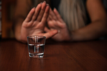 Young woman alcoholic social problems concept sitting refusal of alcohol