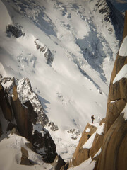 Alpinist in a granite column in massif of Mont Blanch, France