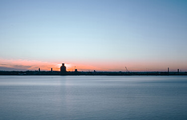 Liverpool, UK. Beautiful colorful long exposure shot of river Mersey from Albert Dock with smooth reflections of night lights from the other side of a shore. 