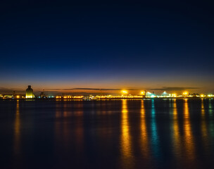 Fototapeta na wymiar Liverpool, UK. Beautiful colorful long exposure shot of river Mersey from Albert Dock with smooth reflections of night lights from the other side of a shore. 