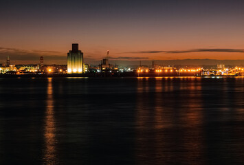 Liverpool, UK. Beautiful colorful long exposure shot of river Mersey from Albert Dock with smooth reflections of night lights from the other side of a shore. 