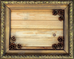 Vintage frame with wood background and fir cones in the corner