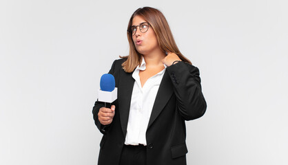 young woman reporter feeling stressed, anxious, tired and frustrated, pulling shirt neck, looking...