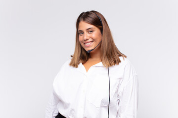 young woman telemarketer smiling happily with a hand on hip and confident, positive, proud and...