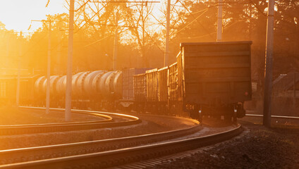 Industrial landscape of a freight train on a railroad at sunset. Transportation of heavy loads. Cargo transportation.