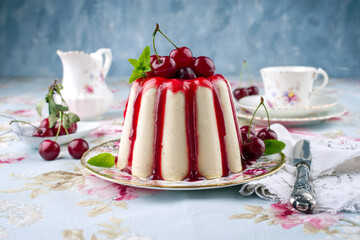 Traditional cherry cheesecake with fruits offered as close-up on design plate