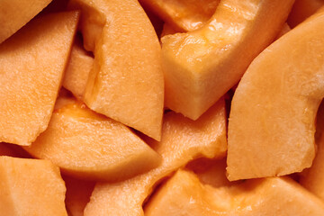 Sliced orange pumpkin, macro texture, melon slices.