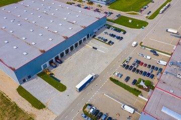 Aerial view of goods warehouse. Logistics center in industrial city zone from drone view. Background texture concept.