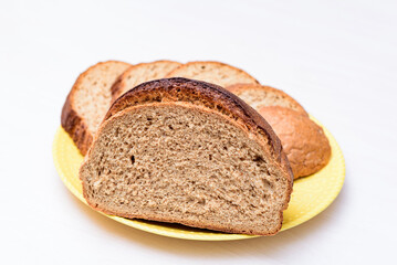fresh buckwheat bread served cut and sliced on the white table. white background close-up, isolated.
