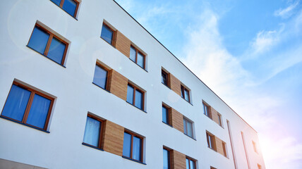 Apartment residential house and home facade architecture and outdoor facilities. Blue sky on the background. Sunlight
