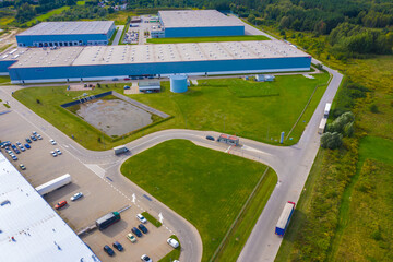 Aerial view of storage and freight terminal with trucks and containers. Industrial background....