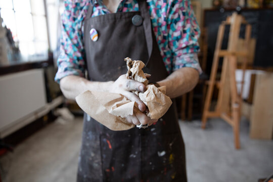 Close Up Male Artist Wiping Chalk From Hands With Paper Towel