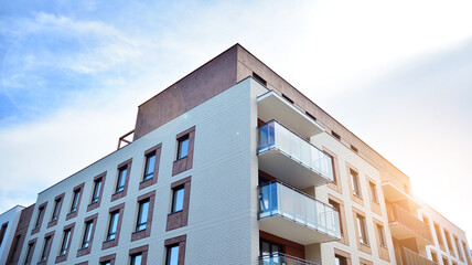 Apartment residential house and home facade architecture and outdoor facilities. Blue sky on the background. Sunlight