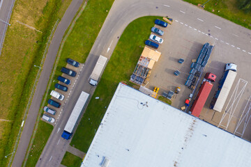 Aerial drone view of group of large modern industrial warehouse or factory buildings in suburban city area.Logistic transportation cargo terminal