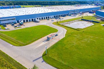 Aerial Shot of Industrial Loading Area where Many Trucks Are Unloading Merchandise.