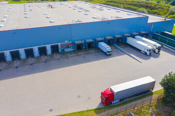 Aerial Shot of Industrial Loading Area where Many Trucks Are Unloading Merchandise.